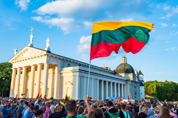 Vilnius / Lithuania - August 23 2019: Lithuanian flag in the Cathedral square in a celebration day of freedom and independence, with Lithuanians people celebrating together