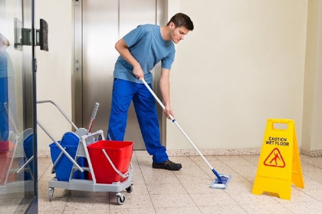 A cleaner sweeping a floor.